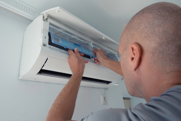 HVAC technician installing filters to new AC system