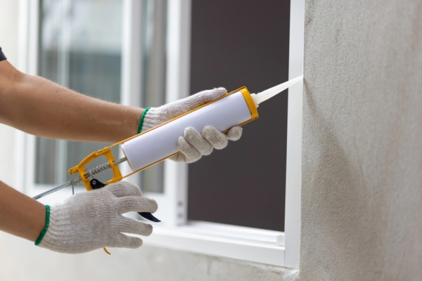 worker sealing window leaks