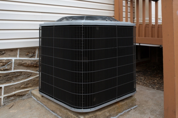 air conditioner condenser installed outside the house