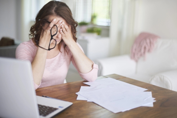 woman feeling bad after computing power outage unexpected expenses